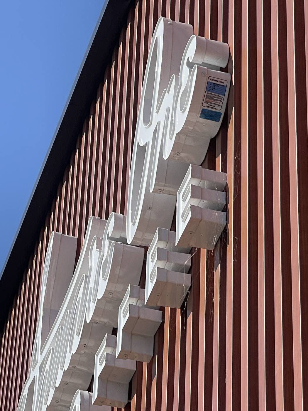 Close view of a Crown Signs channel letter mounting detail