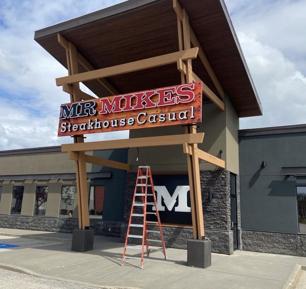 Mr. Mikes Steakhouse Casual entry pylon and monument sign during installation