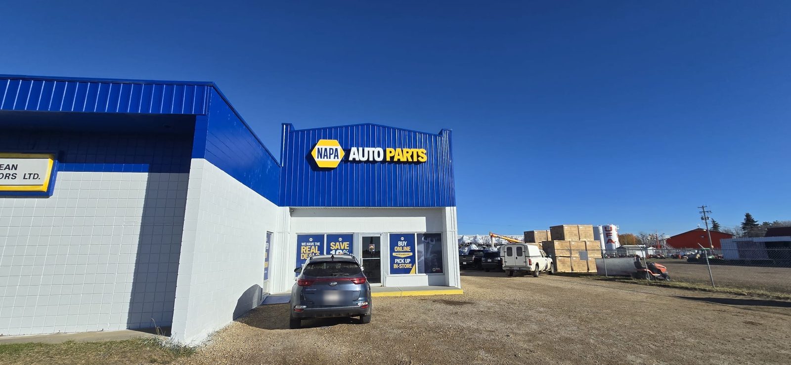 NAPA Auto Parts illuminated building sign on a blue storefront