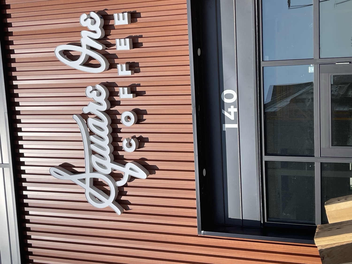 Square One Coffee dimensional storefront channel letters on a wood-panel facade